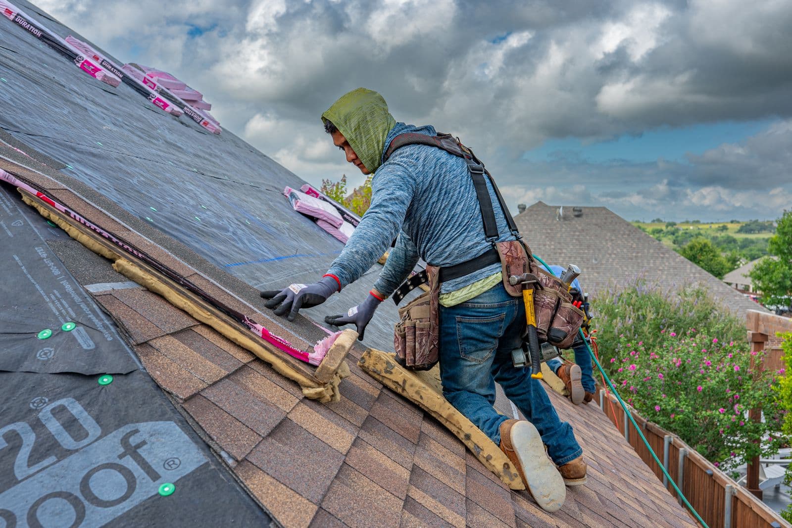 Roofers installing architectural asphalt shingles